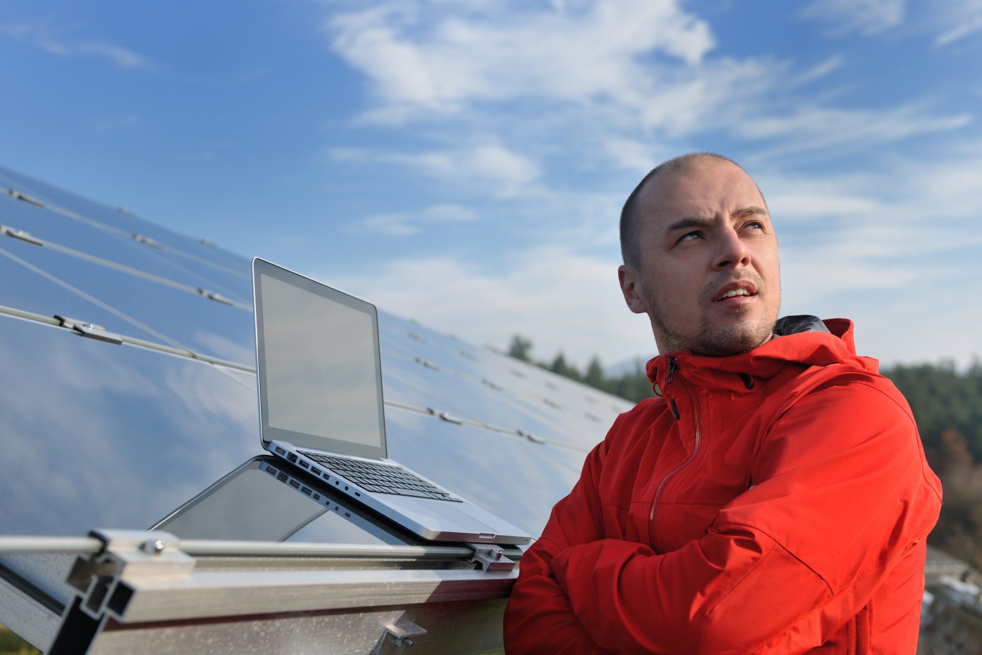 Business man engineer using laptop at solar panels plant eco energy field in background