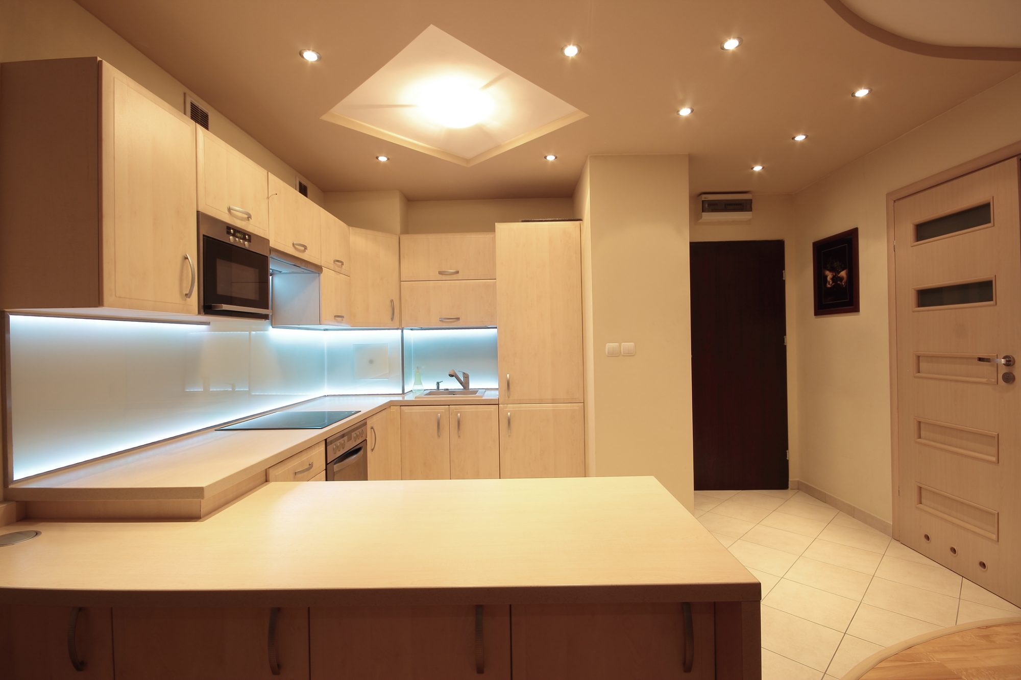 Modern luxury kitchen with white LED lighting.