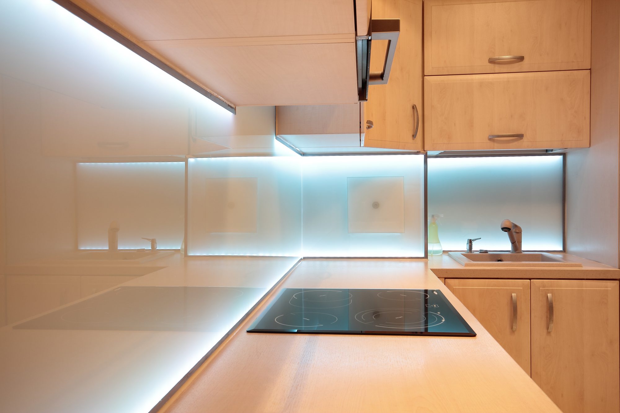 Modern luxury kitchen with white LED lighting.